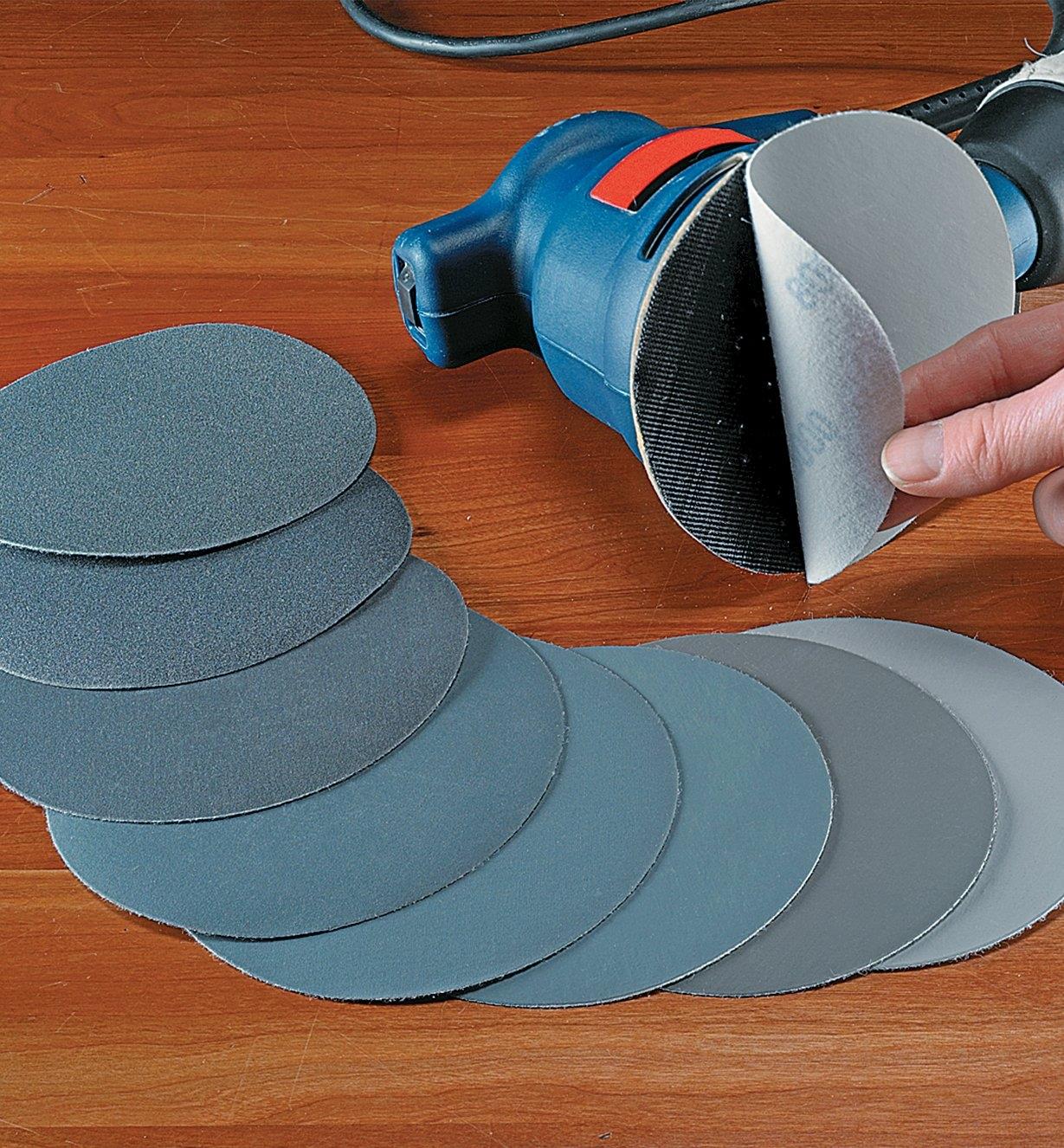 Set of 8 Micro-Mesh Discs spread out beside an electric sander