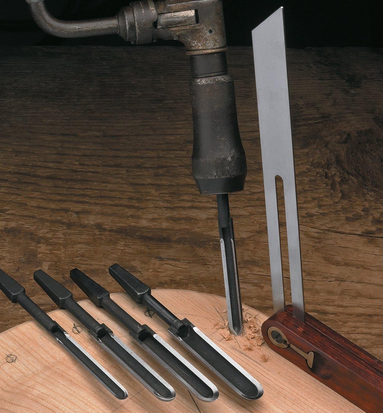 Using a spoon bit to drill into a chair seat, with a sliding bevel guiding the angle