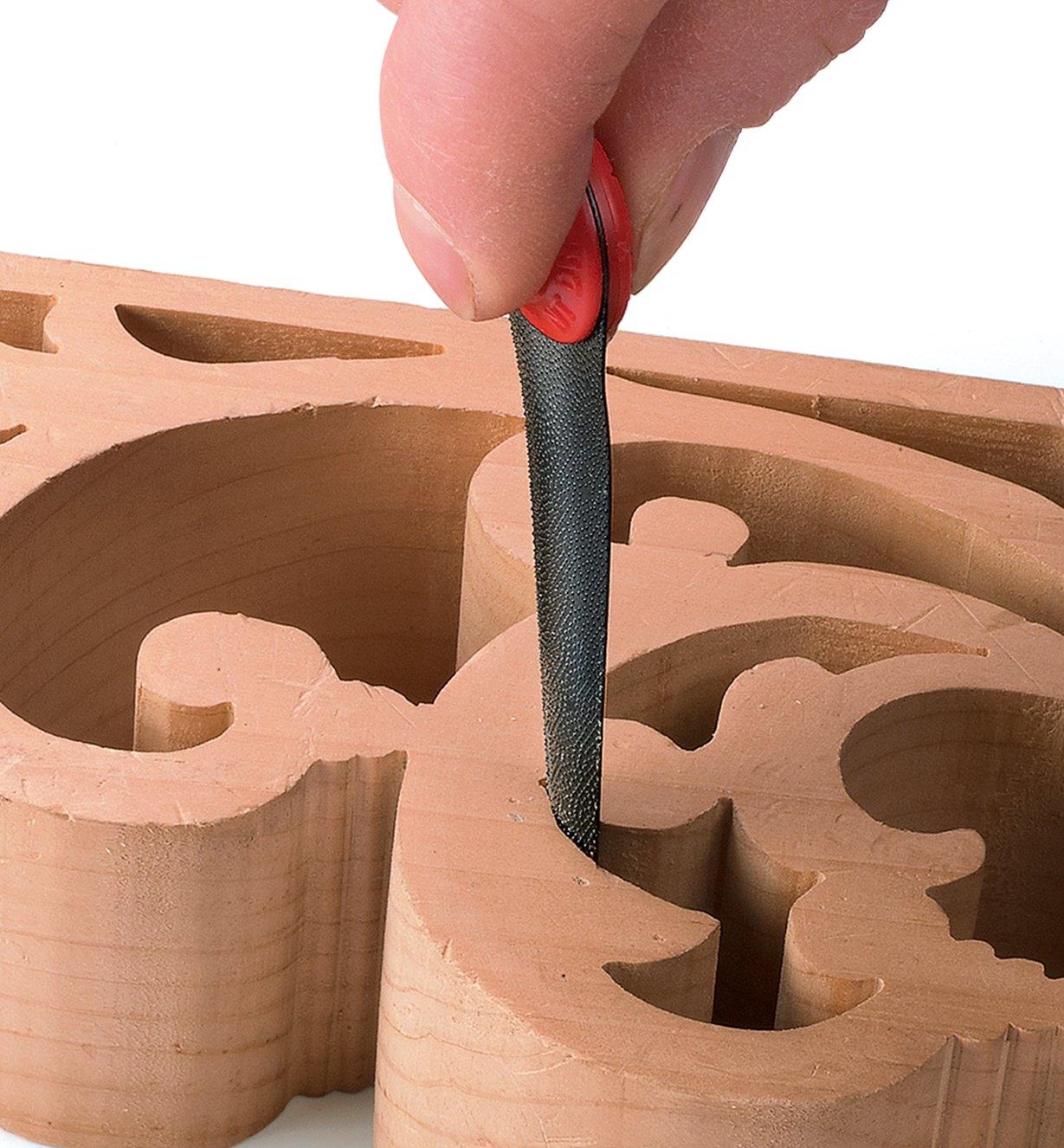 Filing inside a scroll carving with the convex tapered finger file