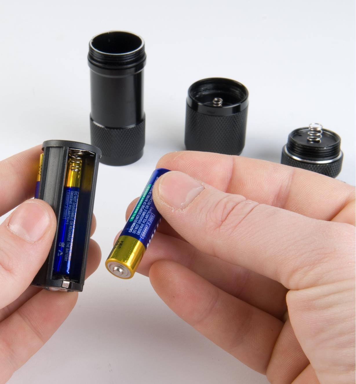 9-LED Flashlight with battery compartment removed to show three AAA batteries