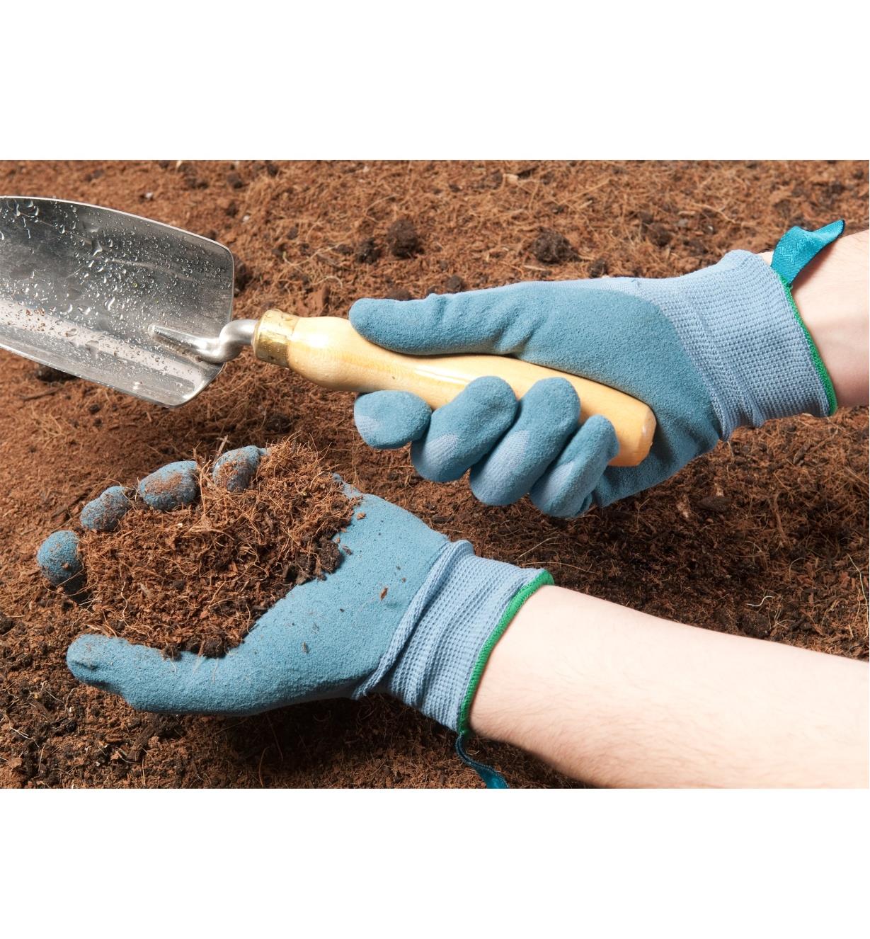 Digging in soil wearing the Lightweight Nitrile Gripper Gloves