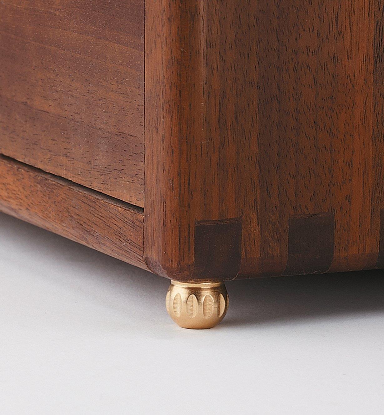 Brass fluted box foot installed on a cabinet