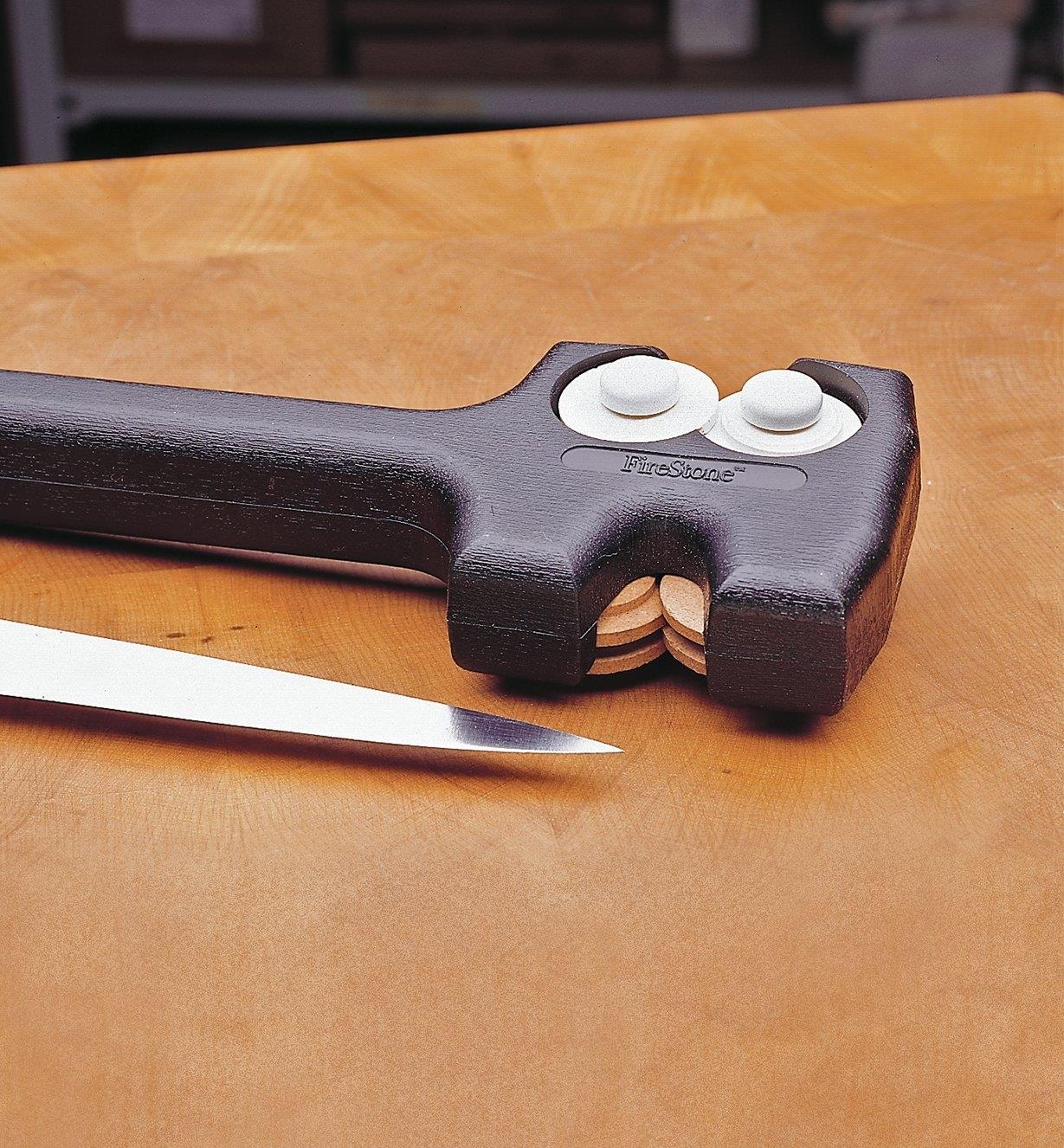 Aiguisoir double déposé sur une table près d'un couteau