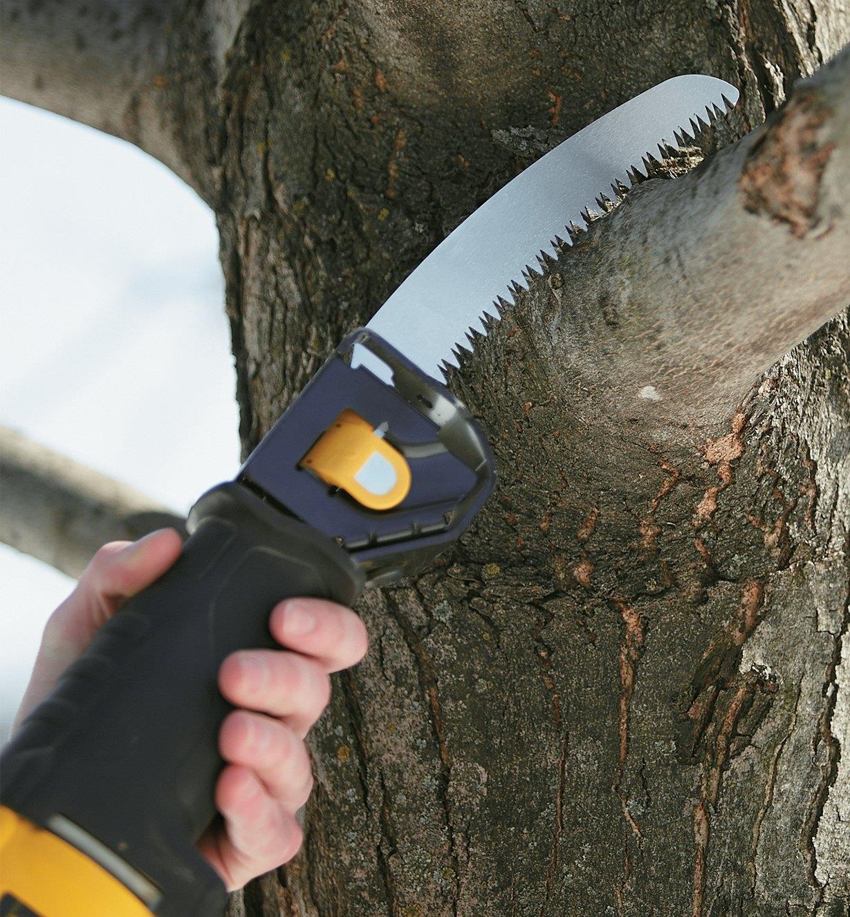 Pruning blade installed in a reciprocating saw being used to cut a tree branch