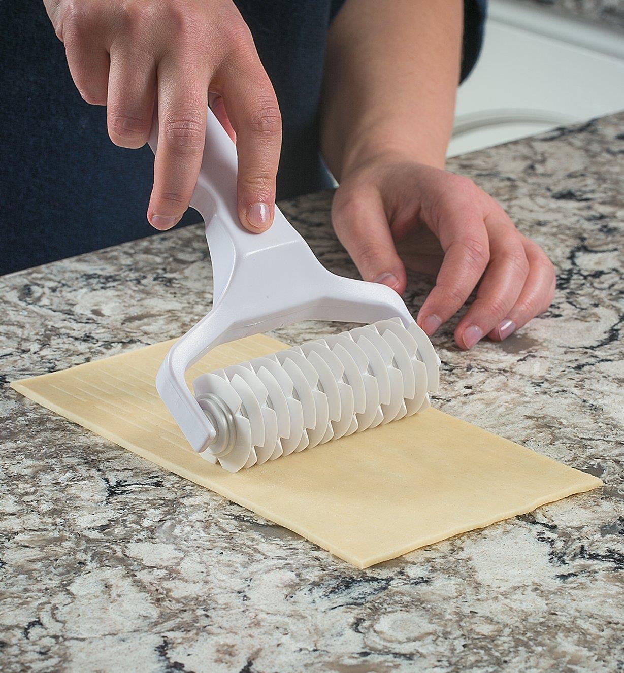 Lattice Cutter being rolled through dough on a countertop