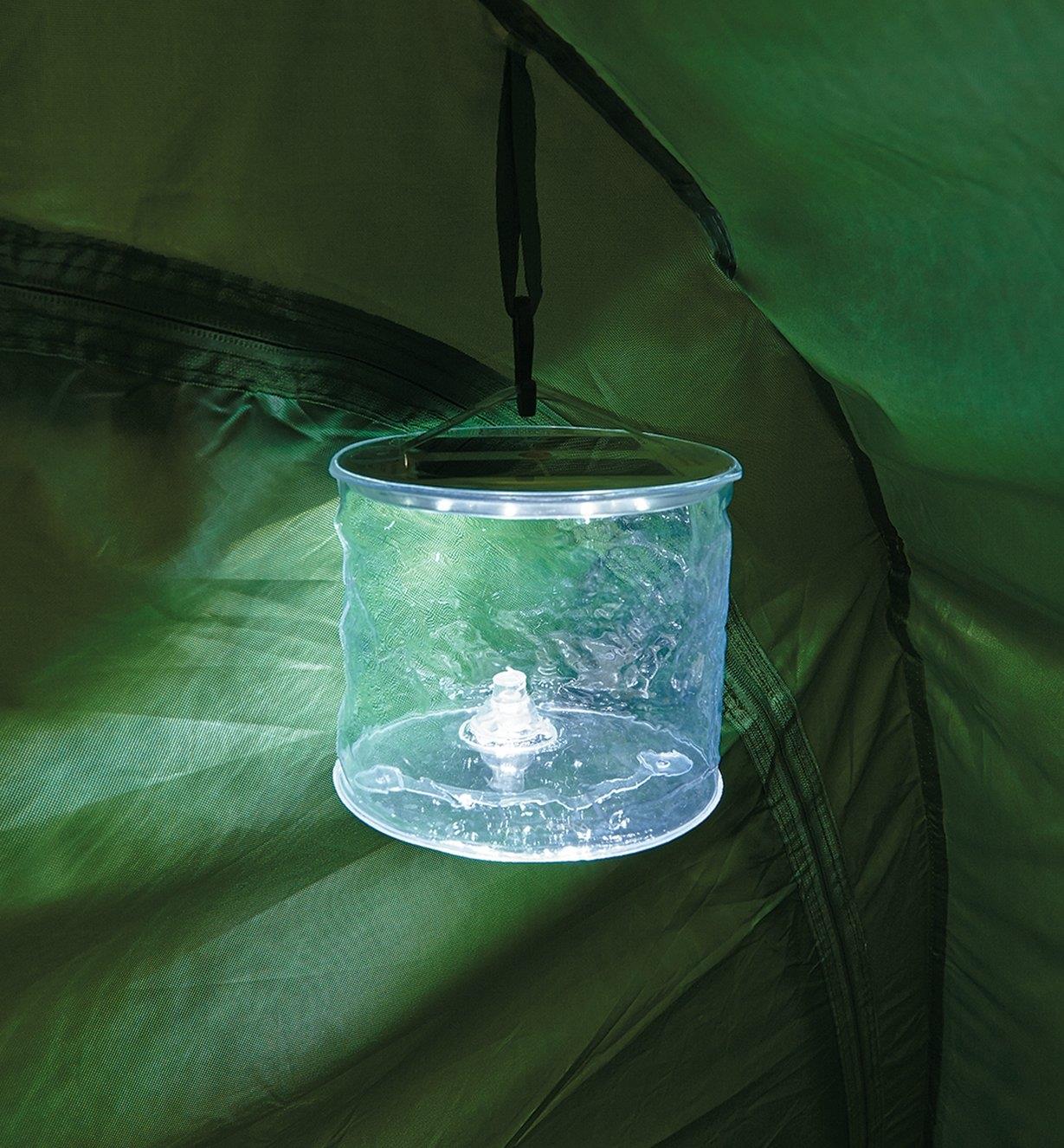 Clear Luci Lantern hanging in a tent