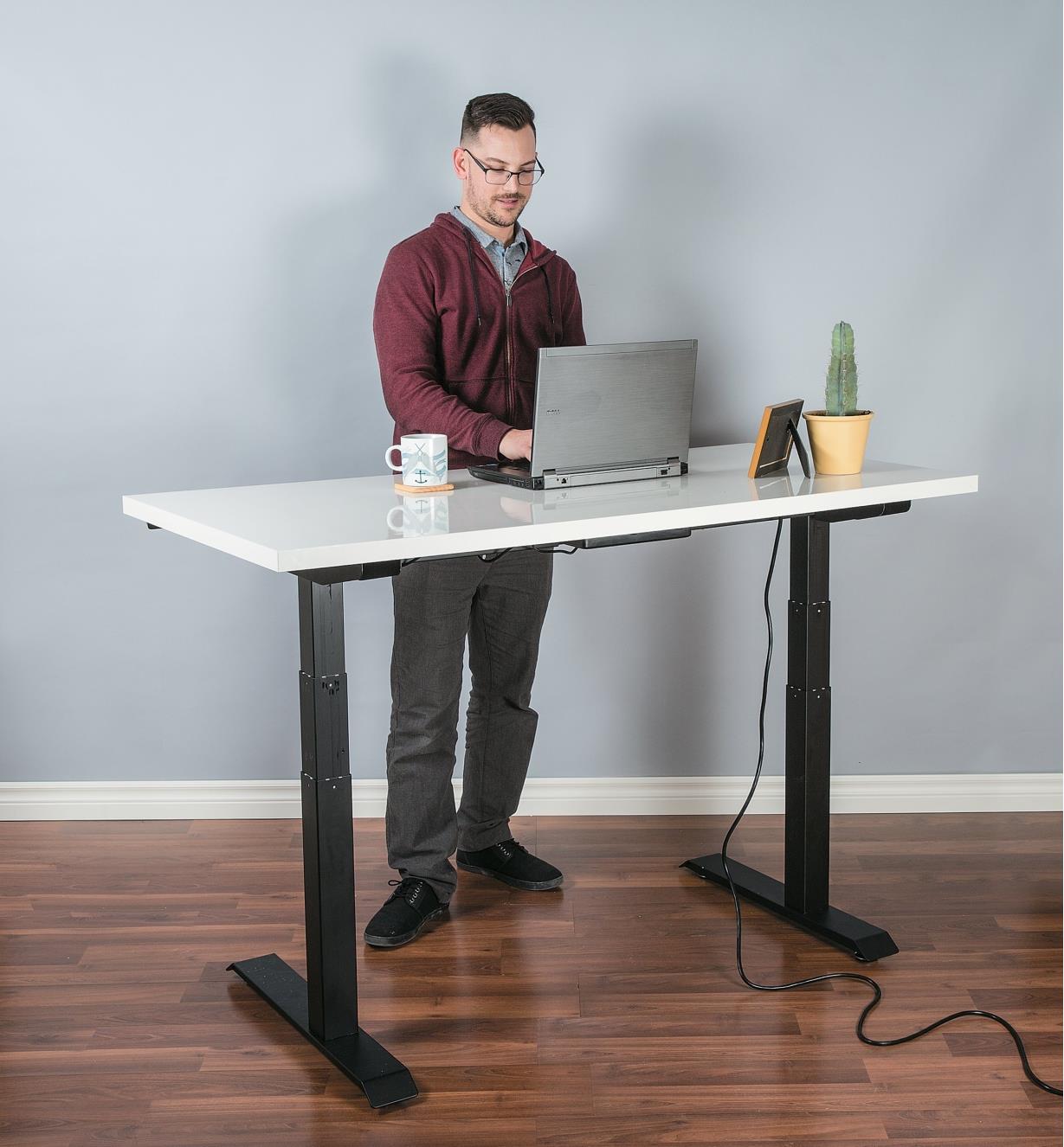 Motorized Table Lift used to support a stand-up desk in an office