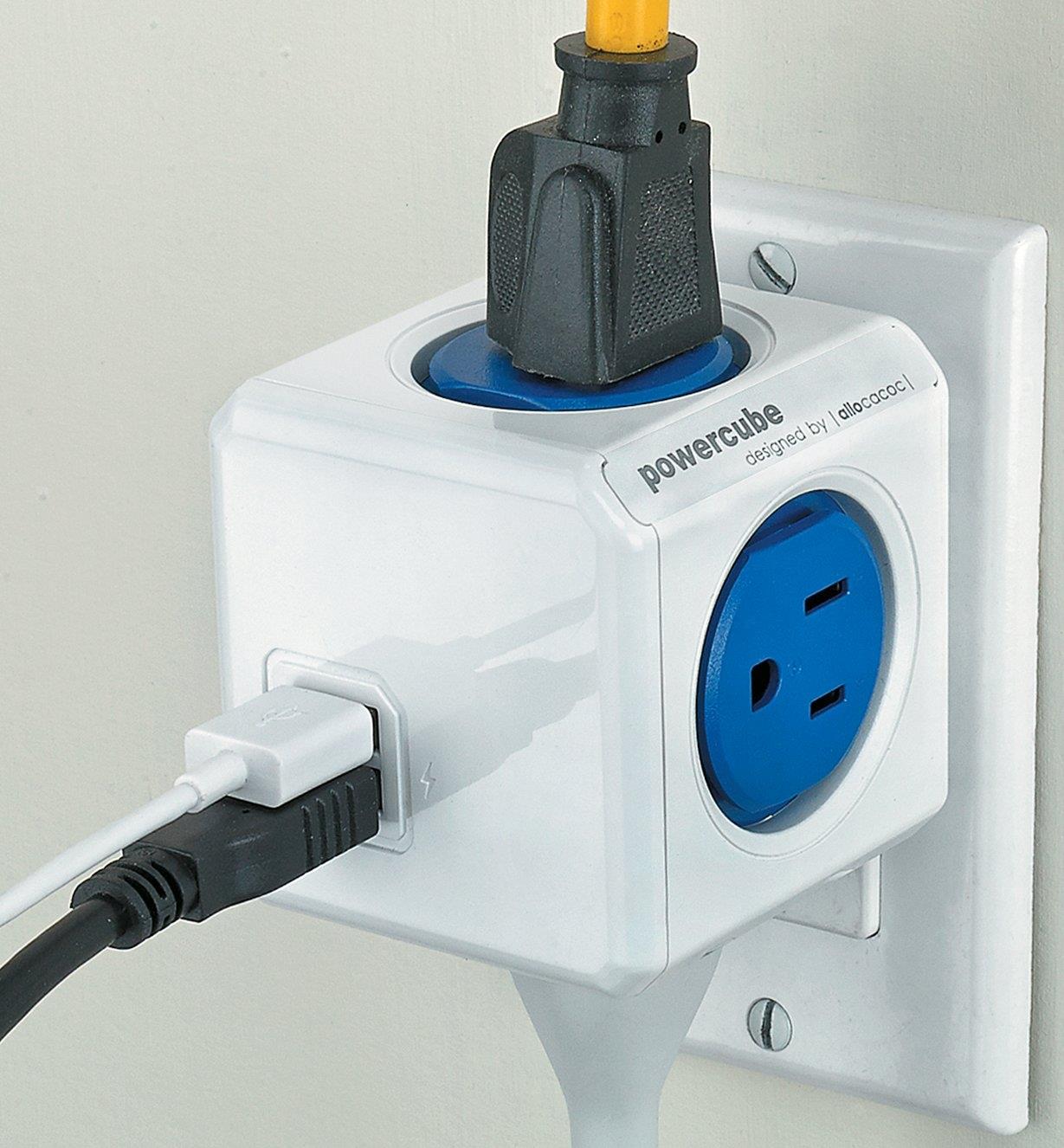 PowerCube with several cords plugged into it, plugged into a wall outlet