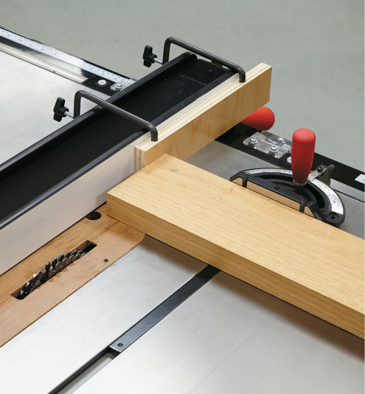 Mounting Clamps holding an auxiliary fence on a table saw