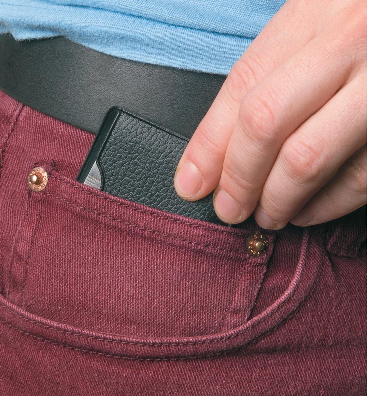 Slipping the Pocket Survival Tool into a pants pocket