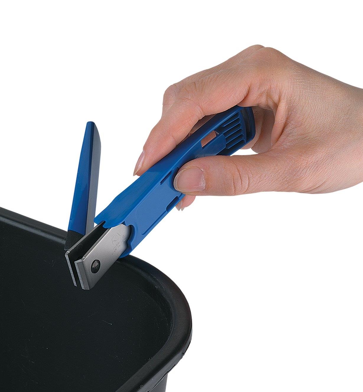 Emptying the Toenail Clipper by tapping it on the side of a trashcan
