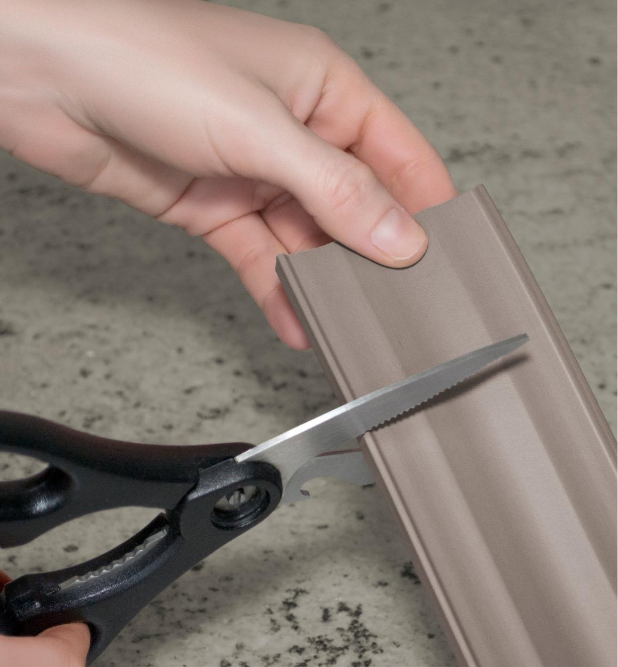 Cutting a Neoprene Storage Liner with scissors
