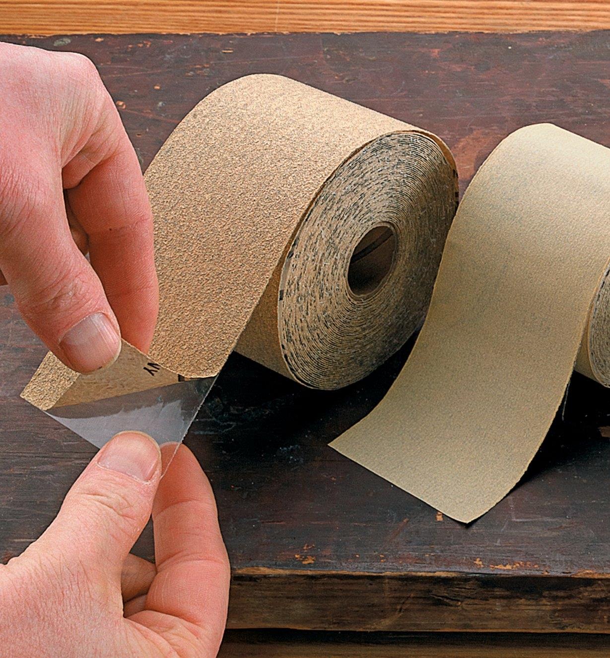 Peeling the backing off a PSA Sandpaper Roll