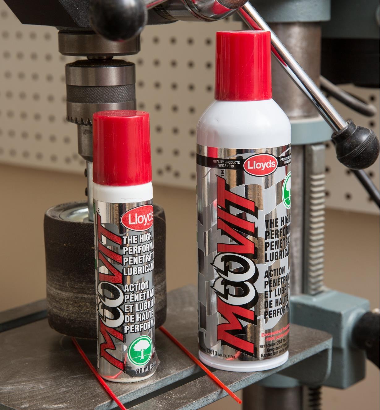 Twio cans of Moovit Penetrating Lubricant sitting on a drill press