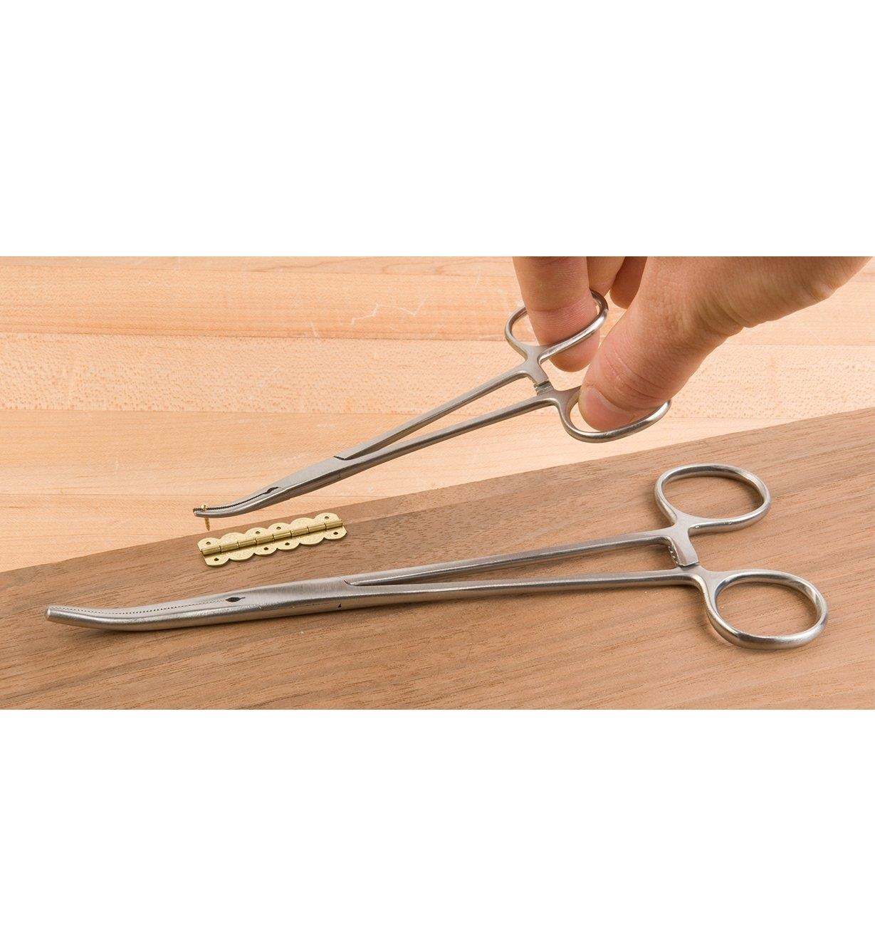 Using Offset Forceps to grip a small hinge nail for starting