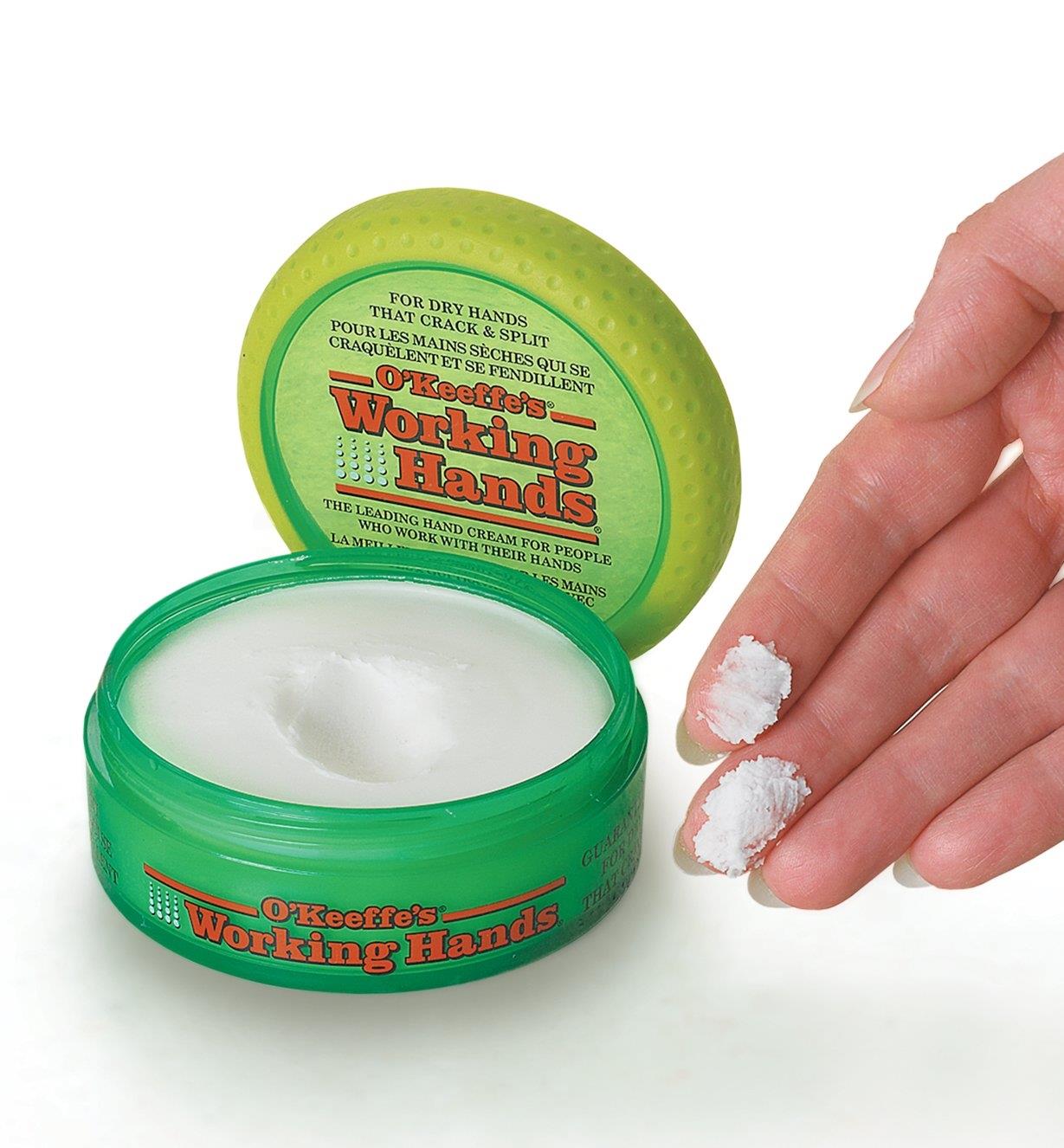 O'Keeffe's Working Hands Cream on a person's fingertips