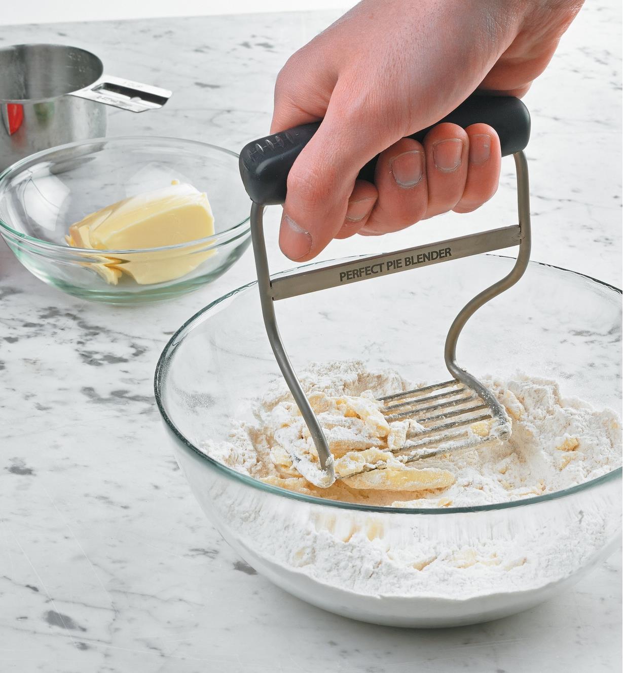 Blending butter and flour in a bowl using the Pastry Blender