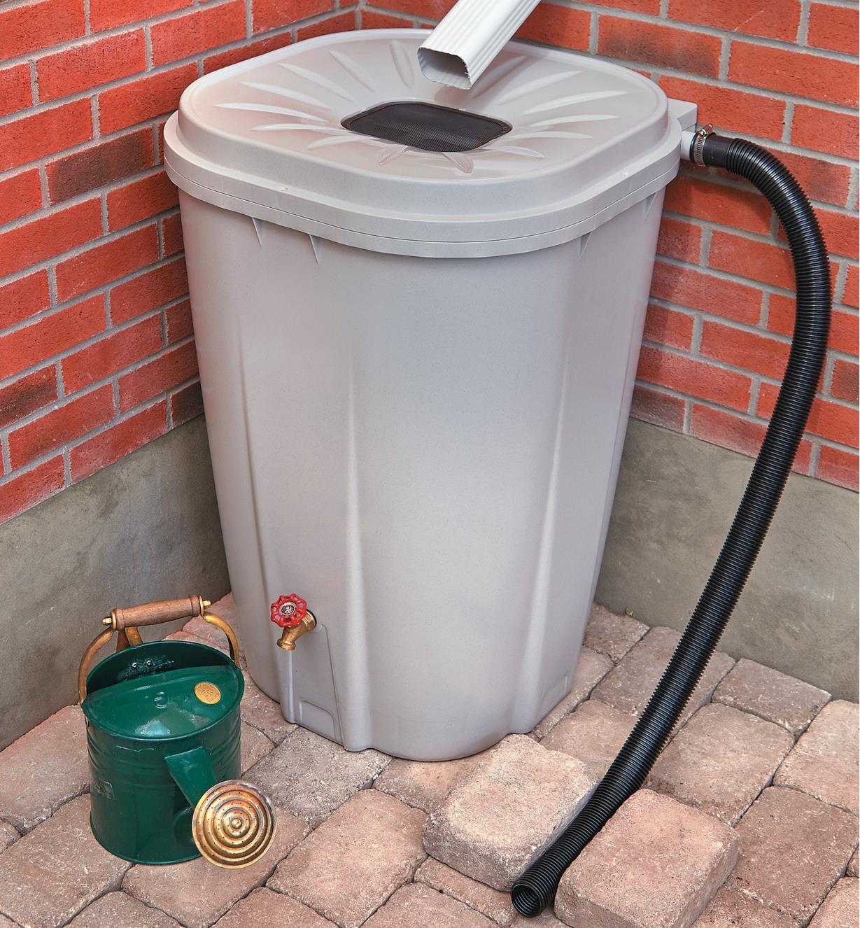 Rain Barrel positioned on a patio under a downspout