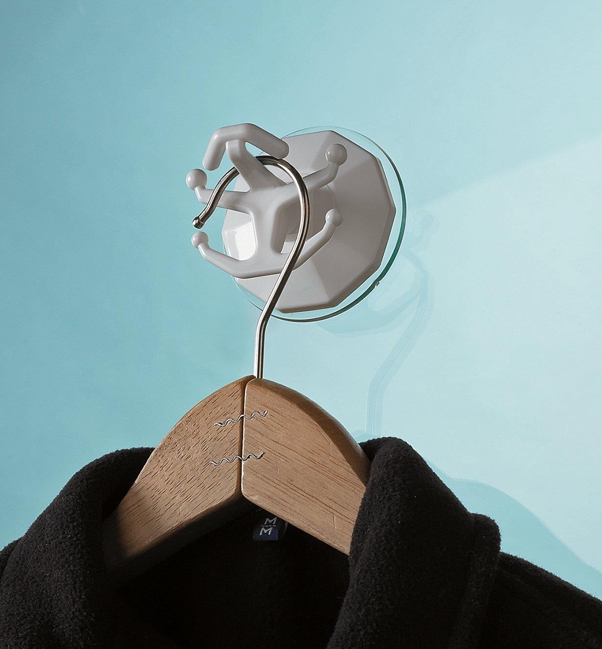 Coat hanger hanging from a Suction Hook