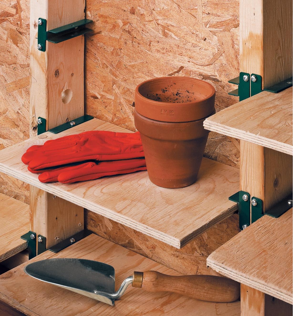 Shelf brackets used to make shelves between wall studs for holding gardening supplies