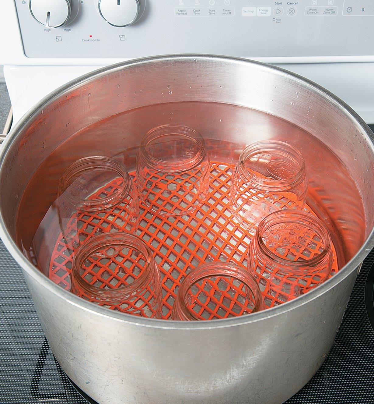 Silicone Canning Mat under canning jars at the bottom of a pot of water