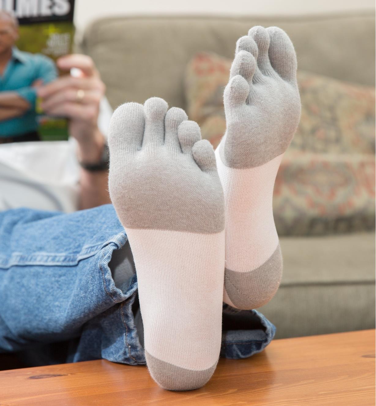 Woman wearing White/Gray Toe Socks with feet resting on coffee table