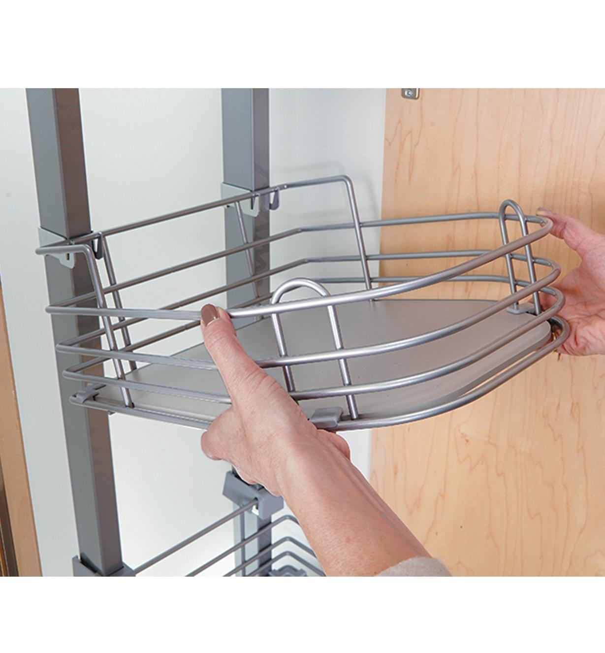 Adjusting the height of a shelf in the pantry unit
