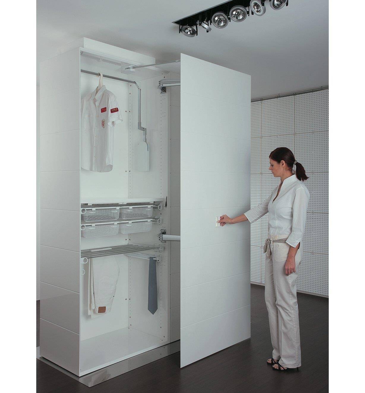 A woman opens a closet door with hinge kit installed