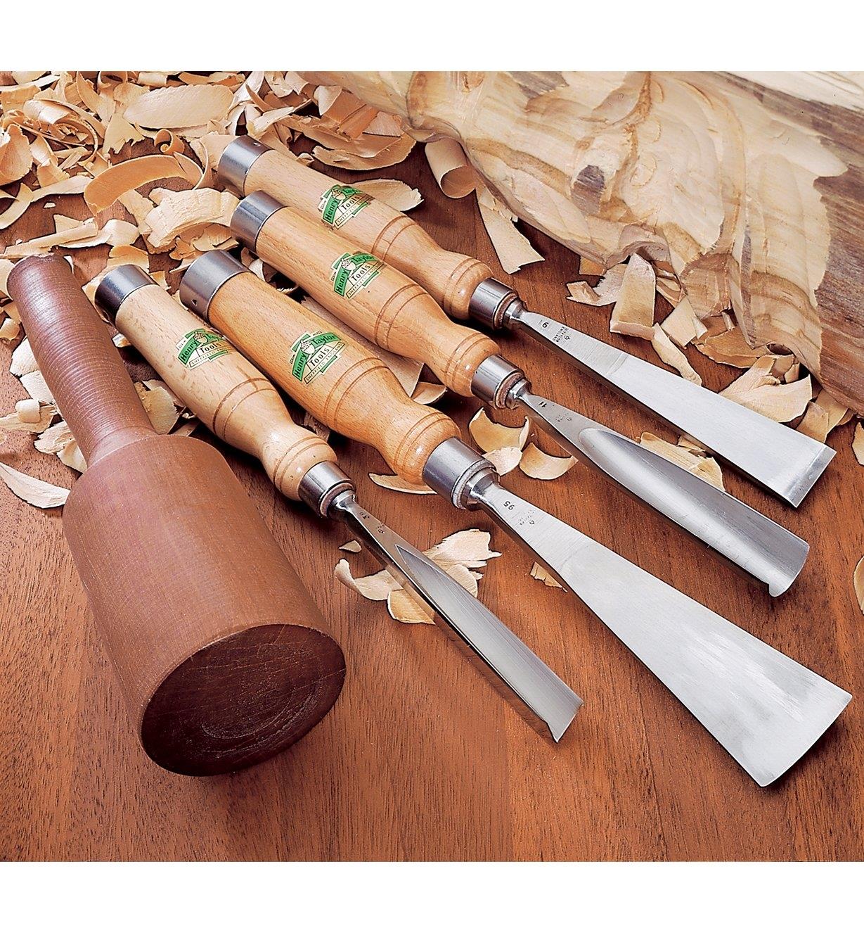 Sculpting Tools lying between a wood carving and a mallet with shavings around