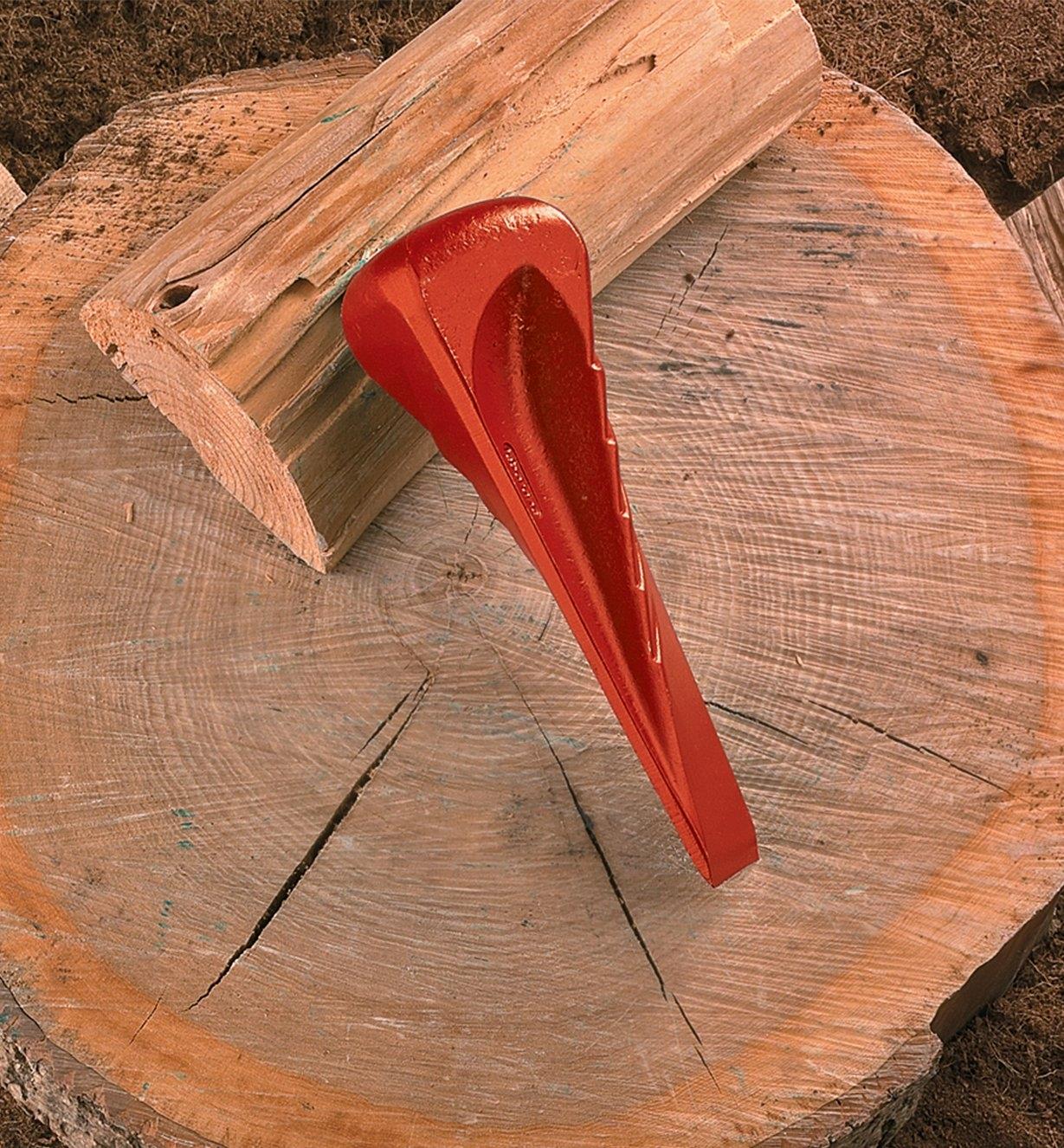 Spiral Splitting Wedge propped on a log on a chopping block