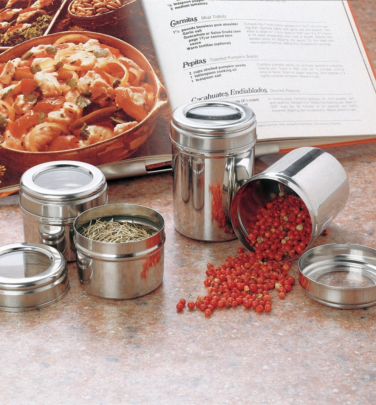 Large and small canisters holding spices