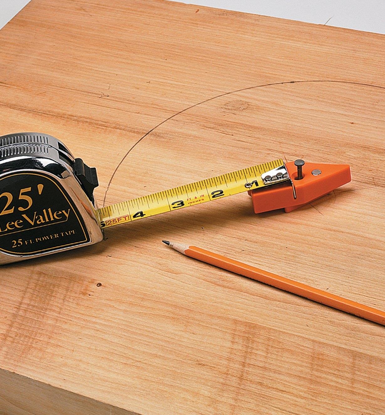 Using a measuring tape and tape tip to draw a circle on wood