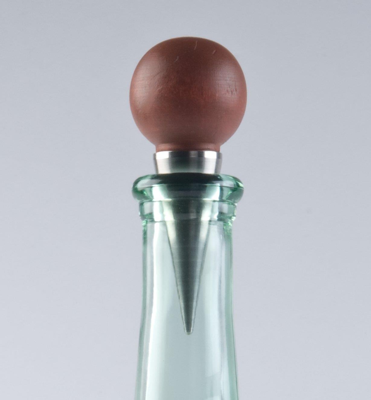 Completed stopper with wooden turning in the mouth of a wine bottle