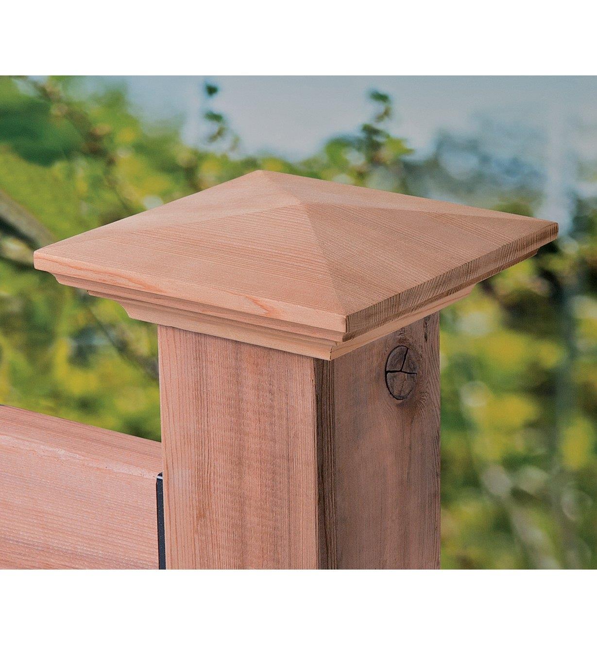 Wooden post cap installed on a deck post