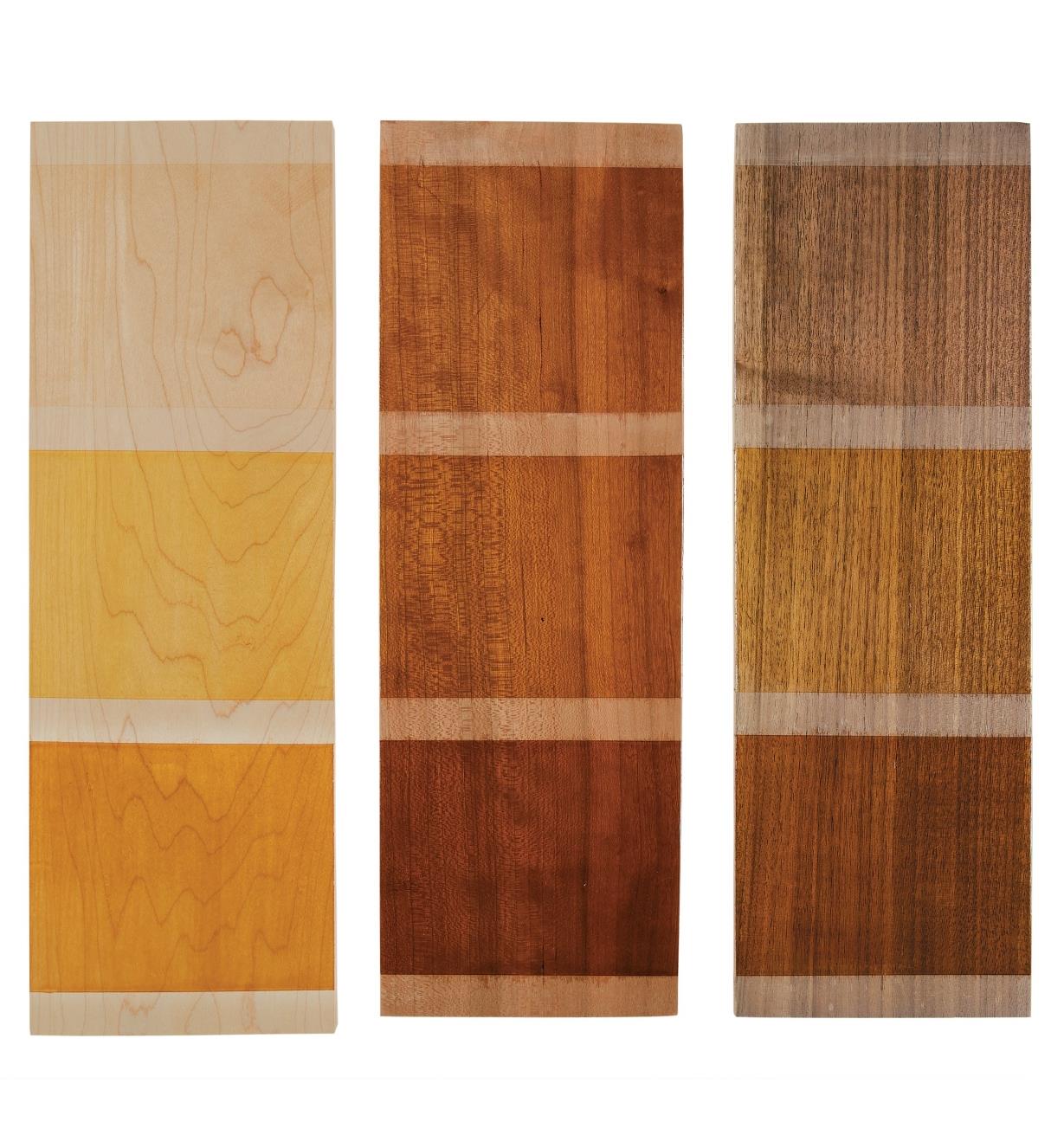 Three wooden boards with samples of shellac colors