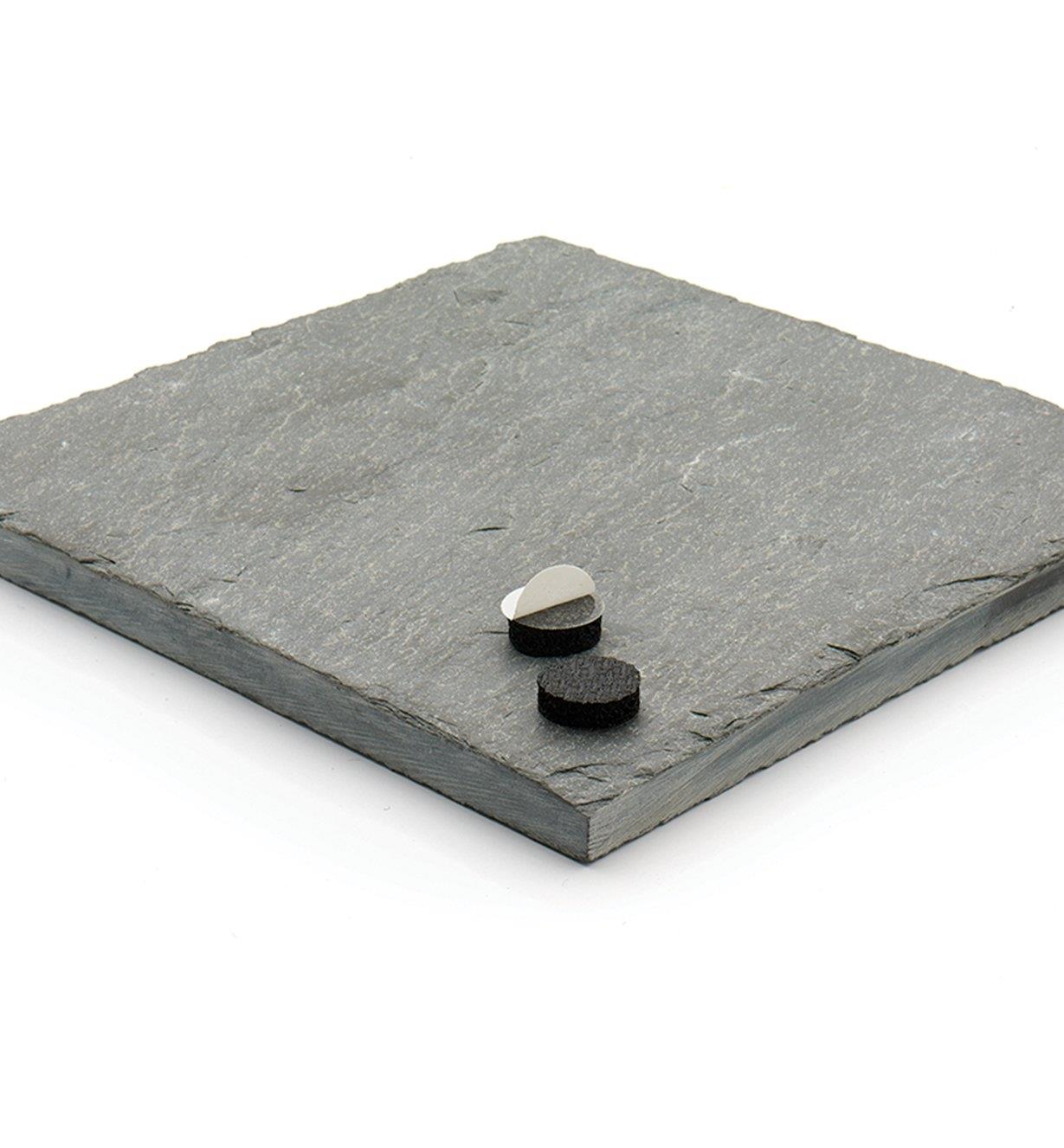 Two 3/8" Pads sitting on a square piece of slate