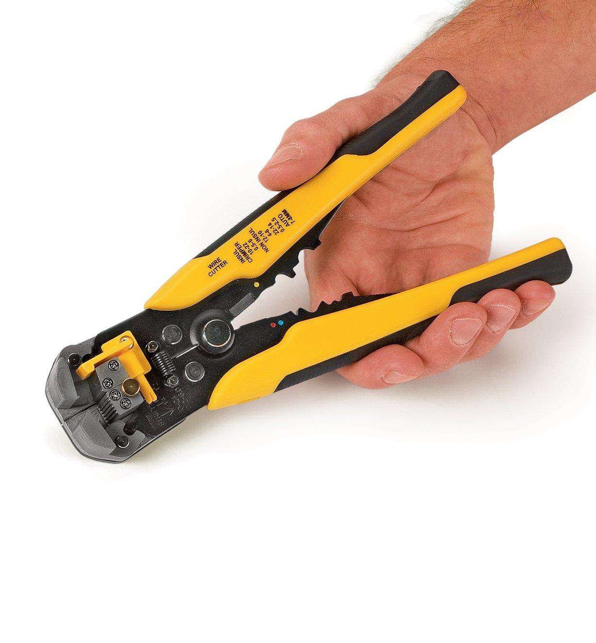 Holding the self-adjusting wire stripper handles