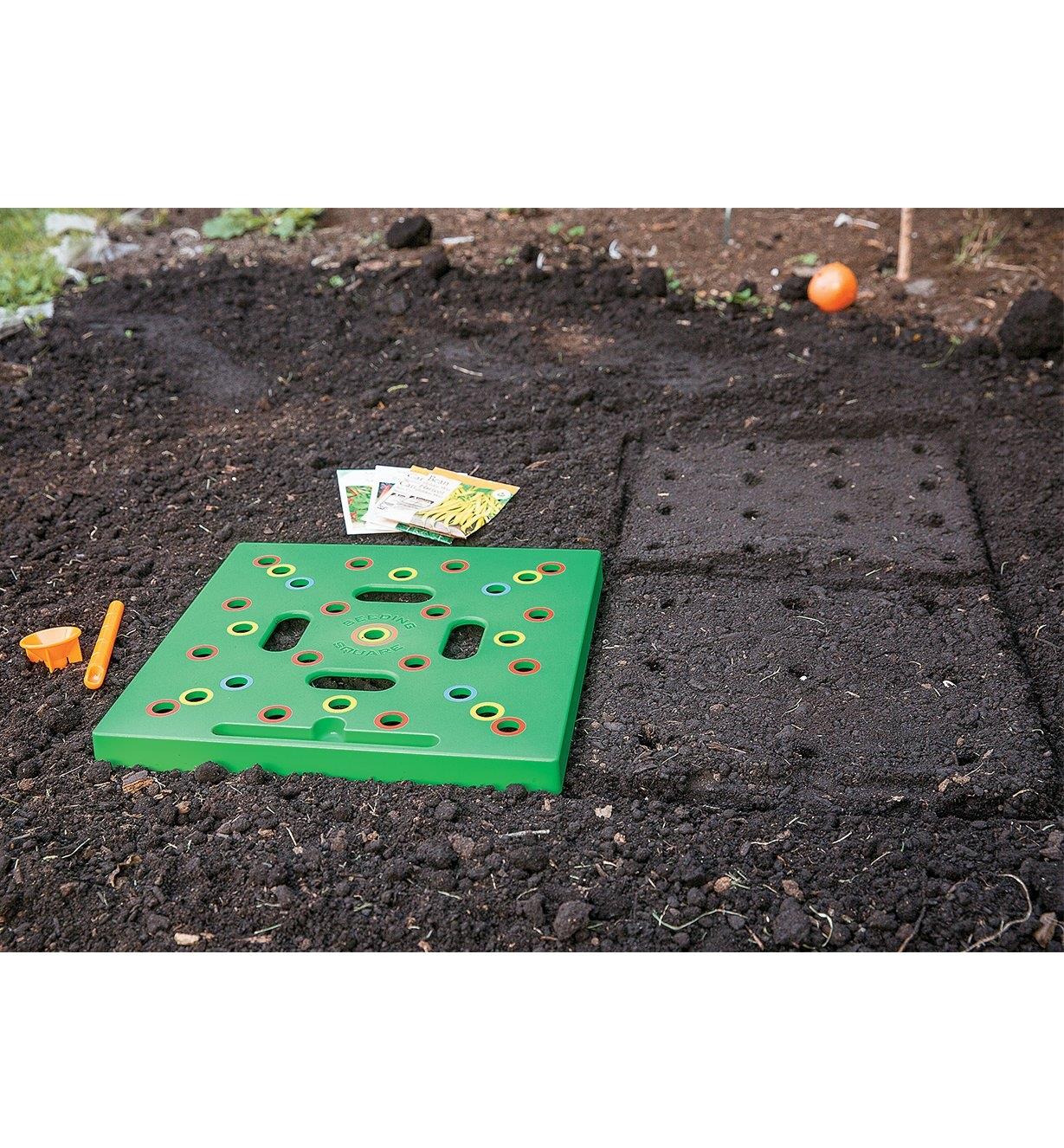 Seeding Square being used to mark seed positions in a garden