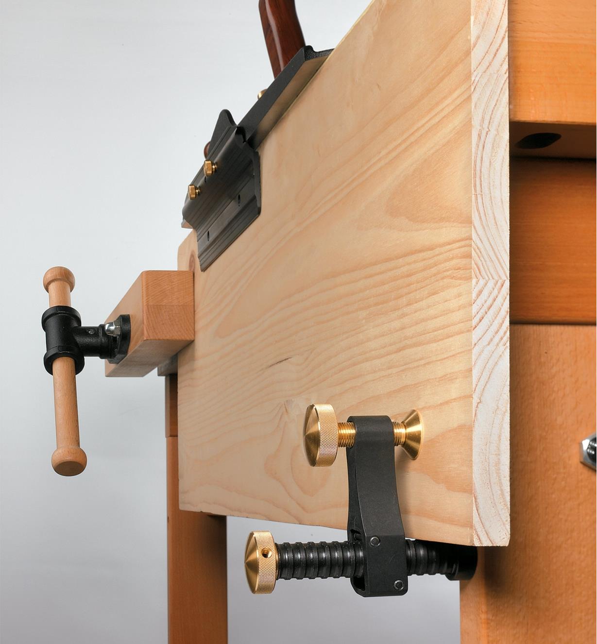 Veritas Surface Clamp securing a board that is being planed