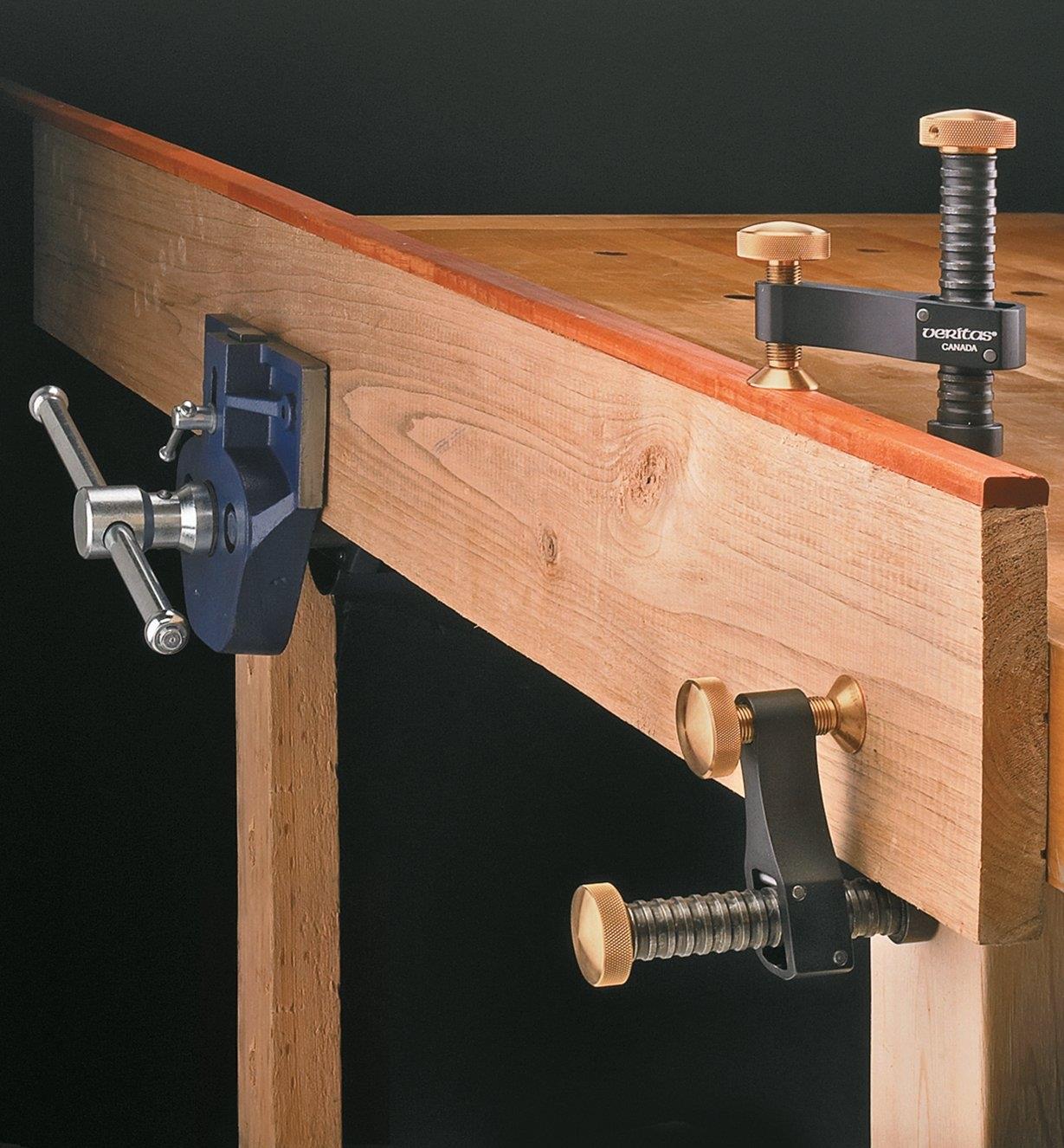Two Veritas Surface Clamps supporting the end of a board that is clamped in a vise