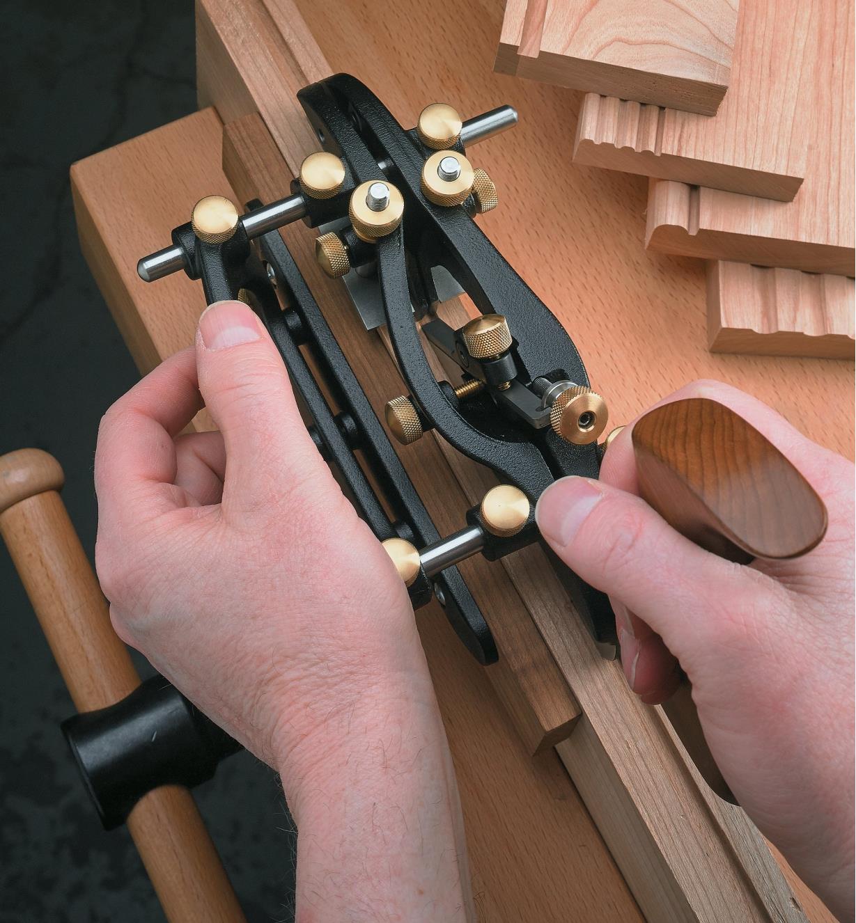 Using the combination plane to cut the groove for a tongue and groove joint on the side of  board