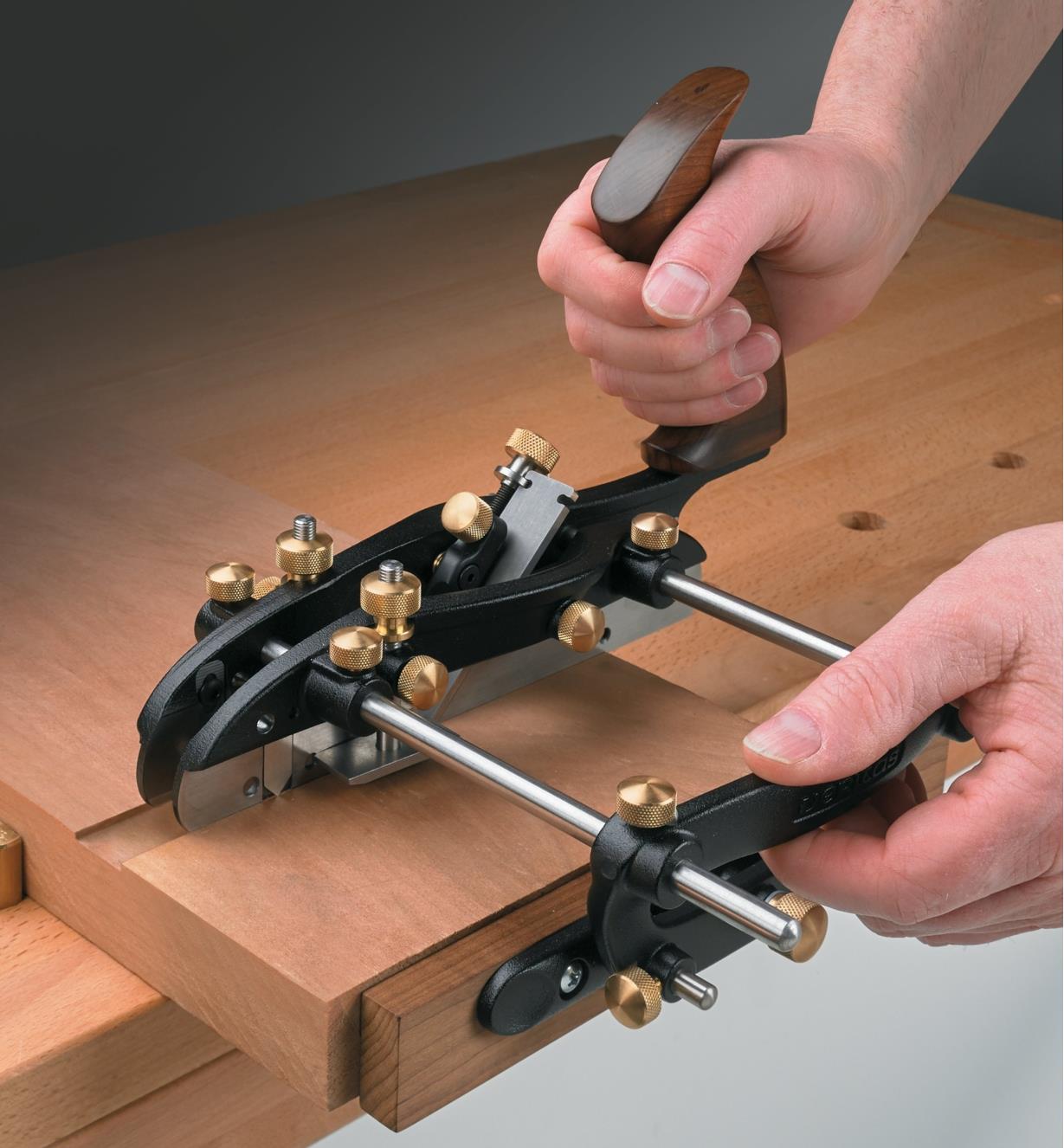 Using the combination plane and fence to cut a dado across a board