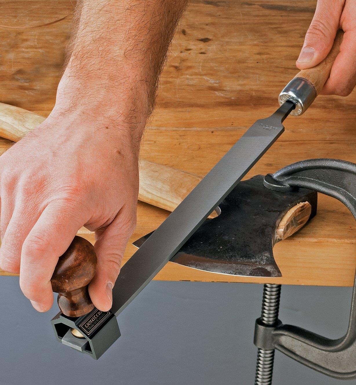 Using a file with the file/rasp handle to sharpen an axe