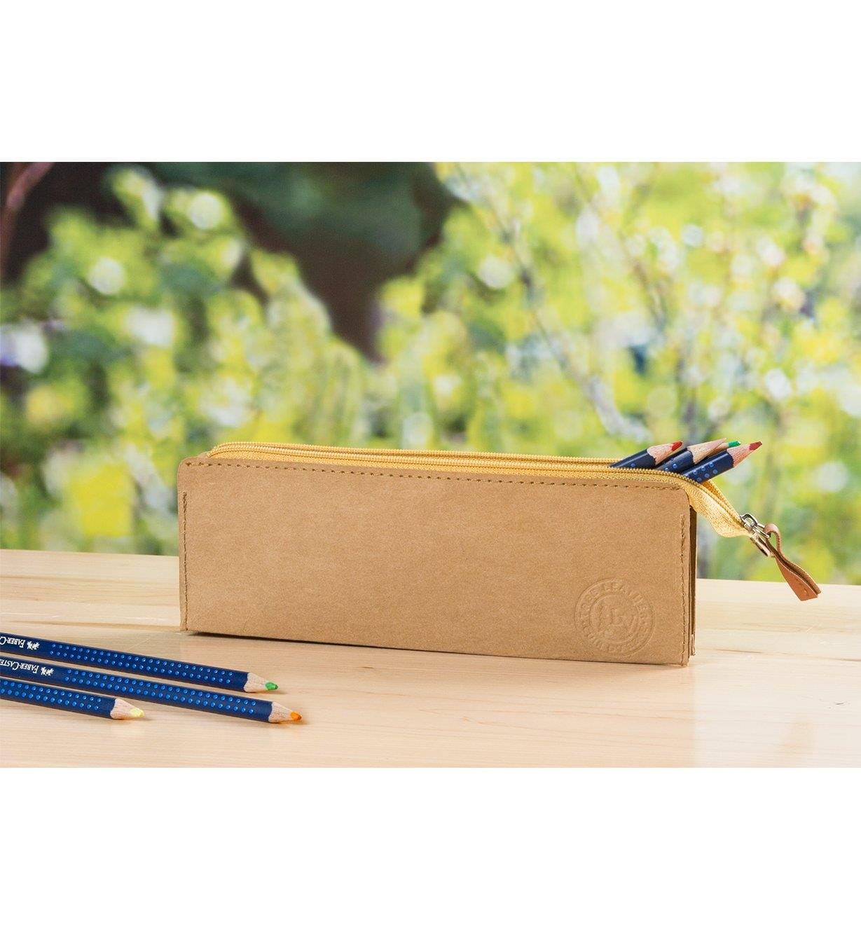 Tree Leather Zippered Pouch on a desk holding colored pencils