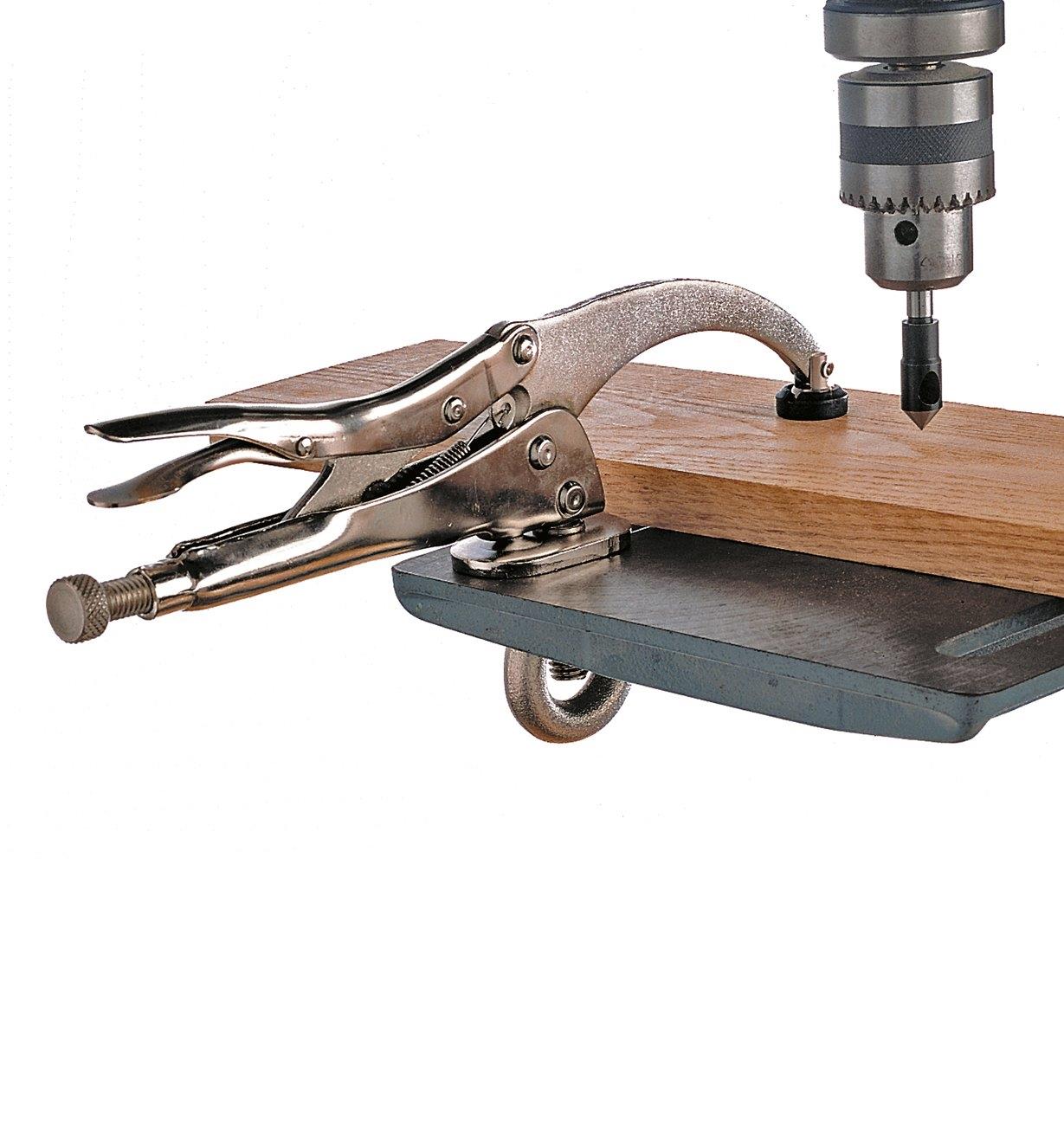 Vise Clamp holding a board on a drill-press table