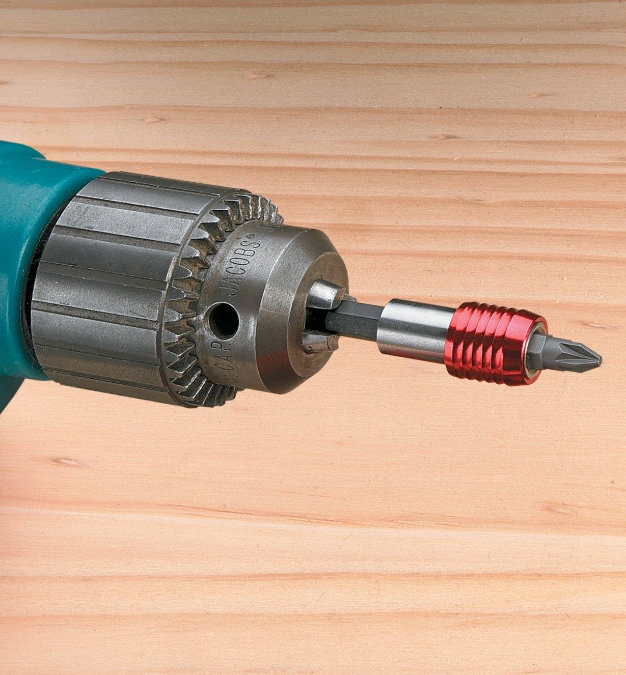 Universal adapter and bit chucked into a drill