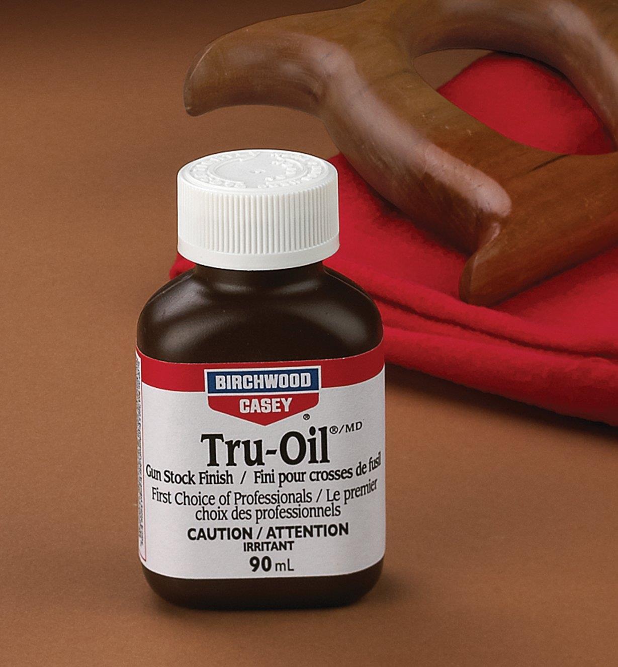 Bottle of Tru-Oil next to a saw handle