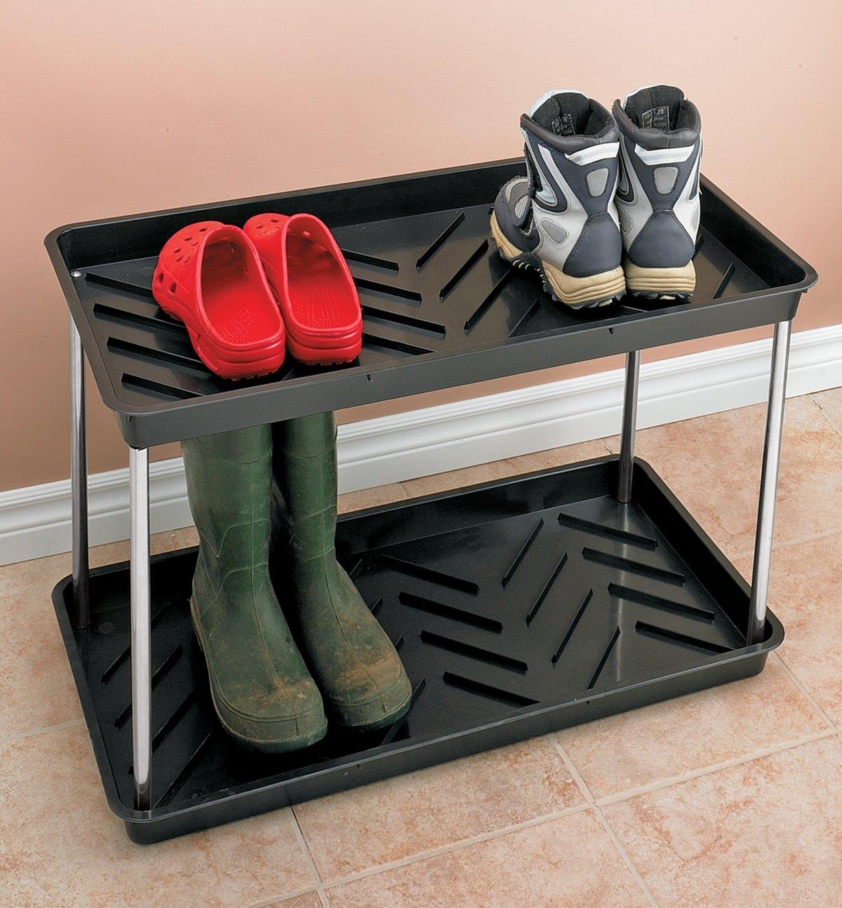 Three pairs of shoes and boots on the Two-Tier Boot Tray