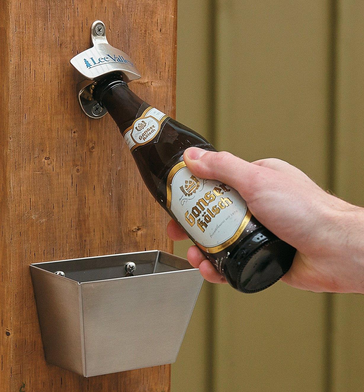 Opening a bottle of beer using the Wall-Mount Bottle Opener, with the Cap Catcher mounted below