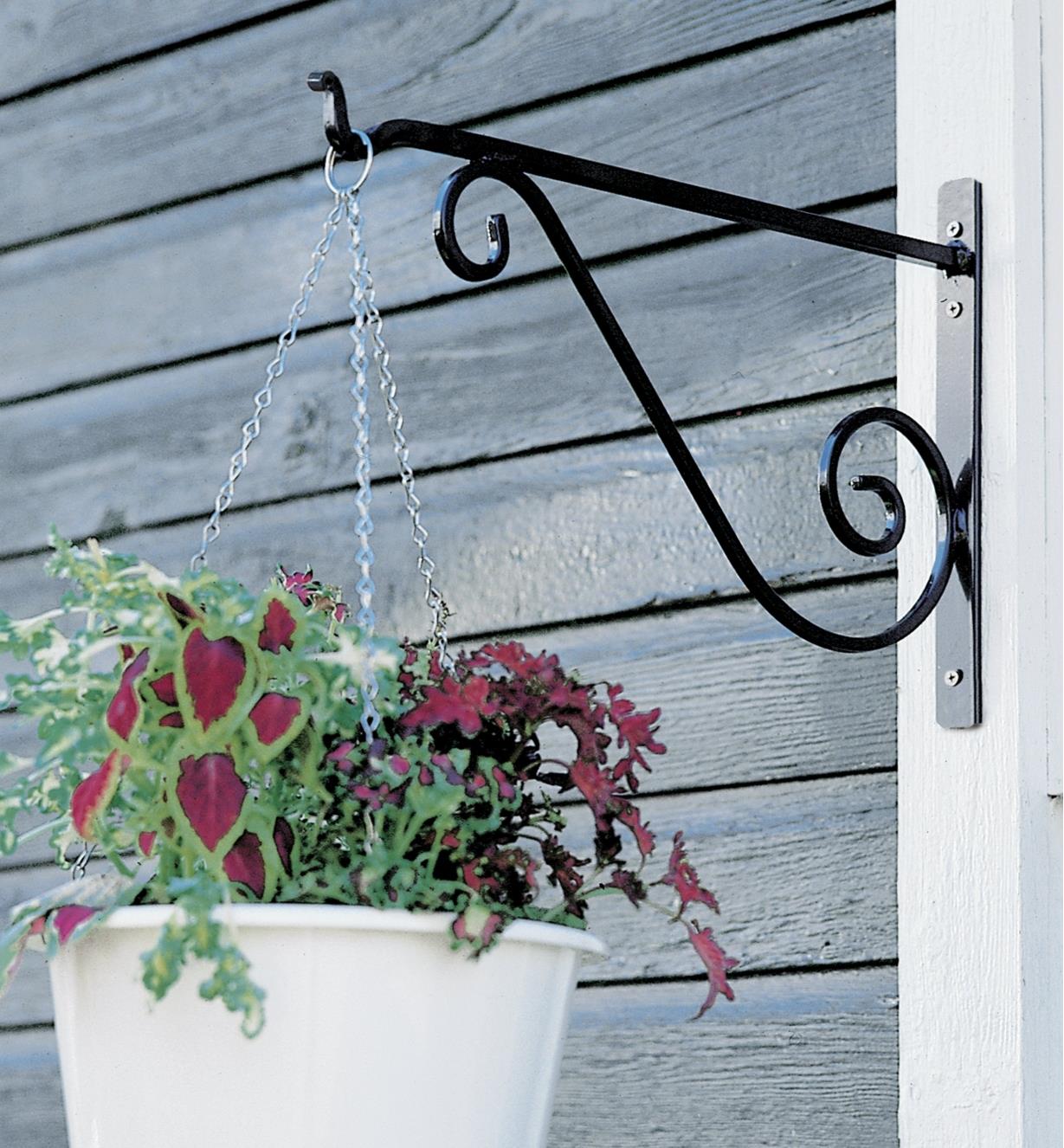 Wrought-Iron Wall Bracket holding a hanging basket on an outdoor post